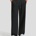 Men's black baggy sweatpants, front view. Wide leg sweatpants men, showing fit and drape.