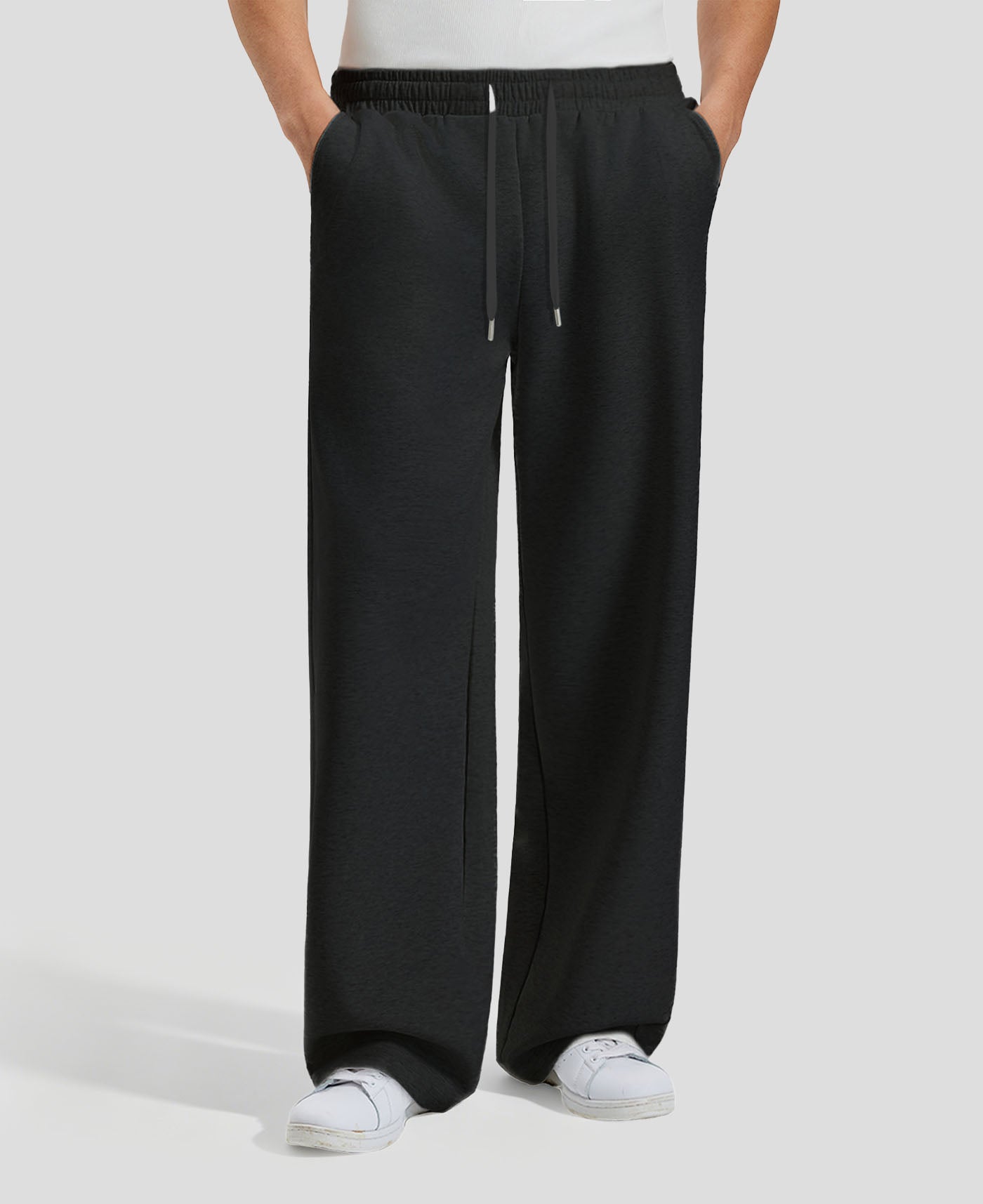 Men's black baggy sweatpants, front view. Wide leg sweatpants men, showing fit and drape.