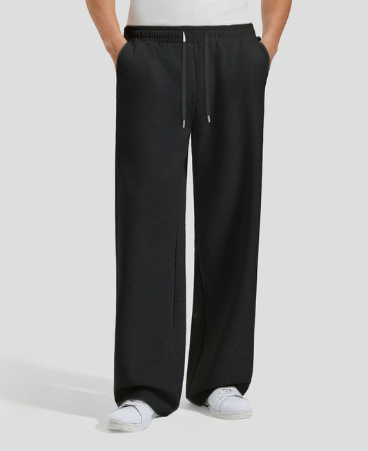 Men's black baggy sweatpants, front view. Wide leg sweatpants men, showing fit and drape.