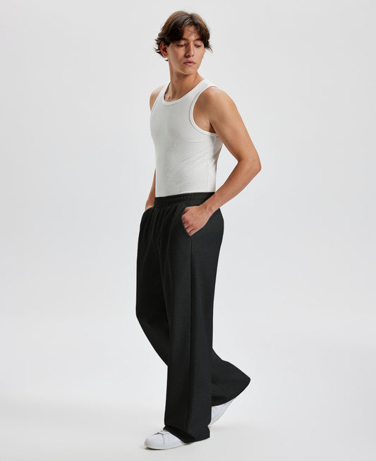 Men's black wide leg sweatpants, side view. Baggy pants men with roomy fit.