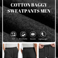 Men's black baggy sweatpants details: fabric, drawstring, elastic waistband and pocket.