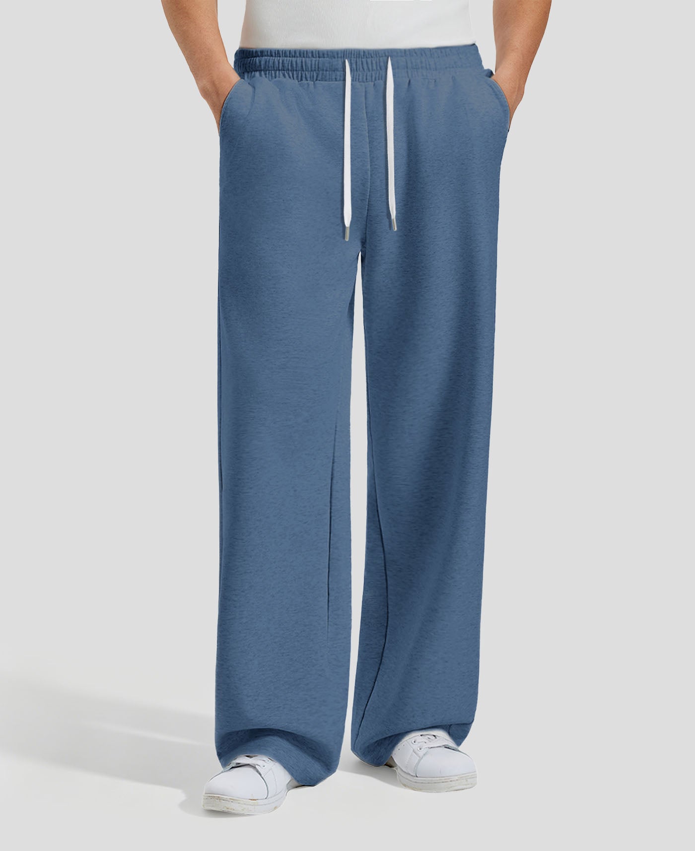 Men's blue baggy sweatpants, front view. Wide leg sweatpants men, showing fit and drape.