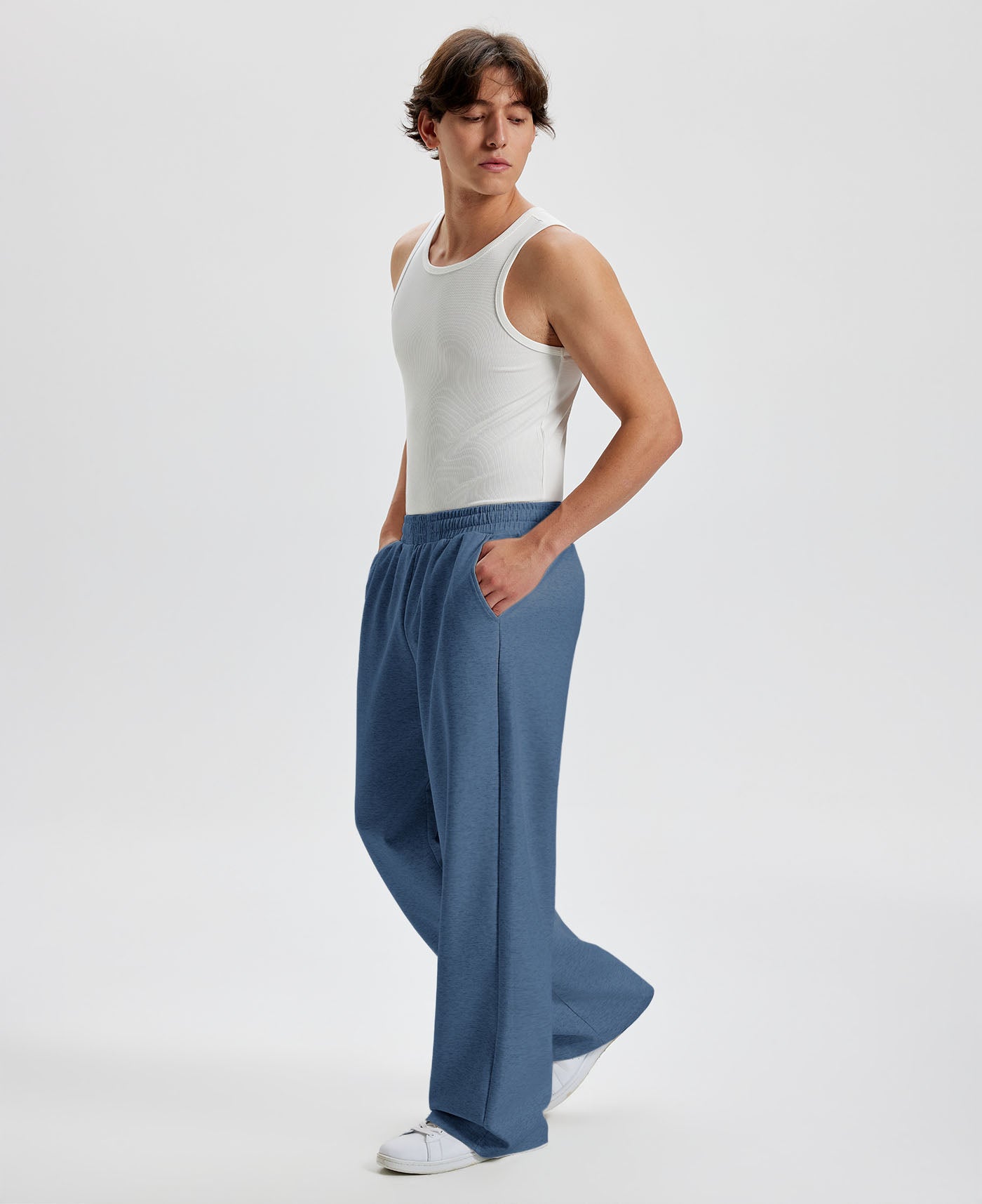 Men's blue wide leg sweatpants, side view. Baggy pants men with roomy fit.
