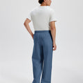 Cotton blue sweatpants for men, back view. Elastic waistband and back pocket.