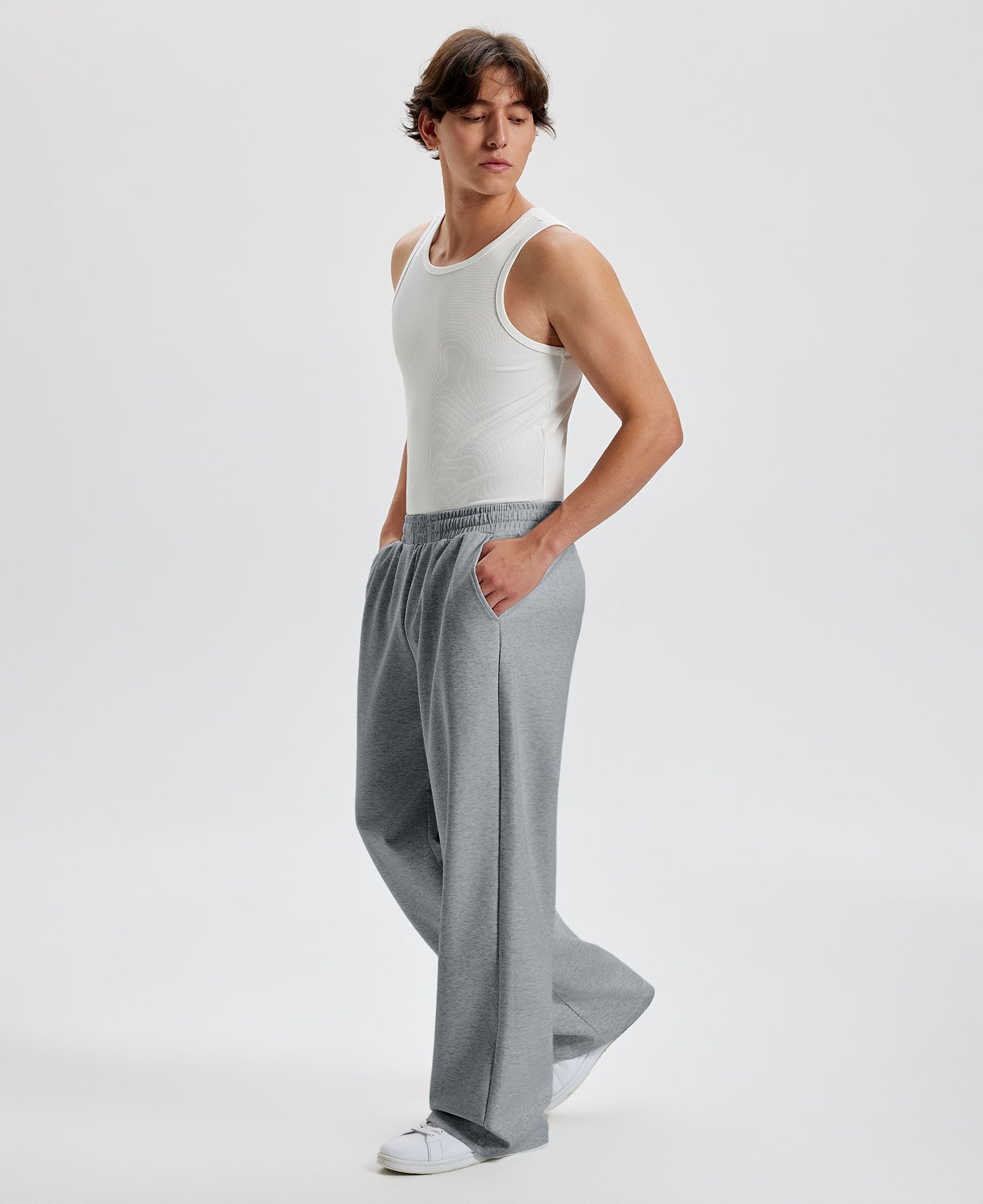 Men's dark grey wide leg sweatpants, side view. Baggy pants men with roomy fit.