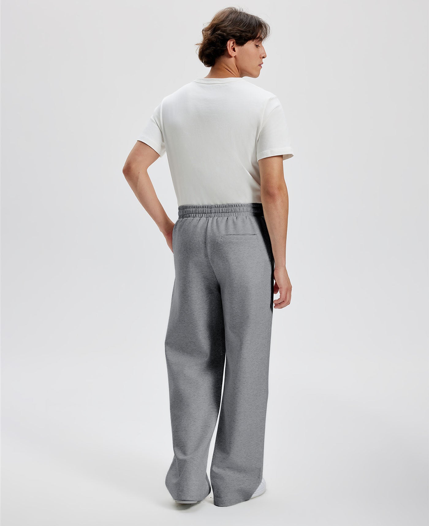Cotton dark grey sweatpants for men, back view. Elastic waistband and back pocket.