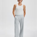 Loose fit light grey sweatpants for men, full outfit. Casual men's sweatpants front look.