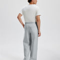 Cotton light grey sweatpants for men, back view. Elastic waistband and back pocket.
