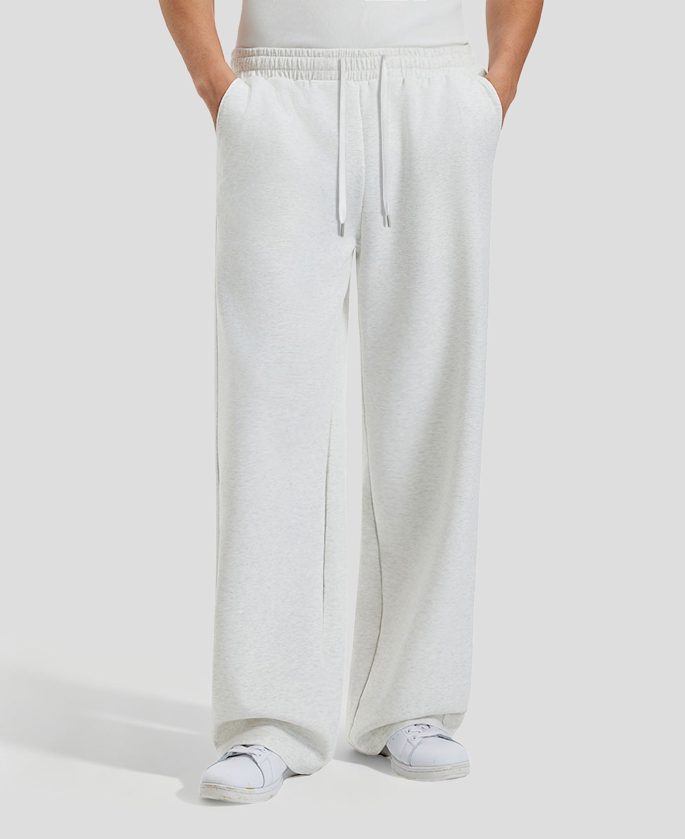 Men's white grey baggy sweatpants, front view. Wide leg sweatpants men, showing fit and drape.