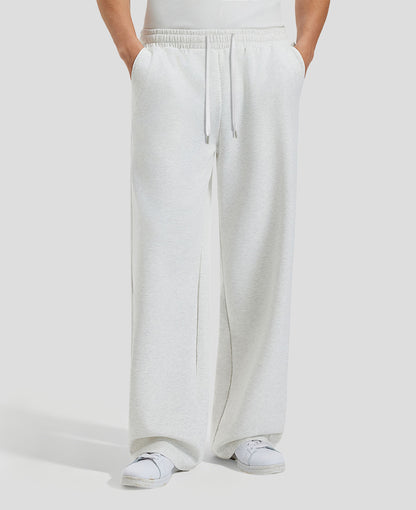 Men's white grey baggy sweatpants, front view. Wide leg sweatpants men, showing fit and drape.