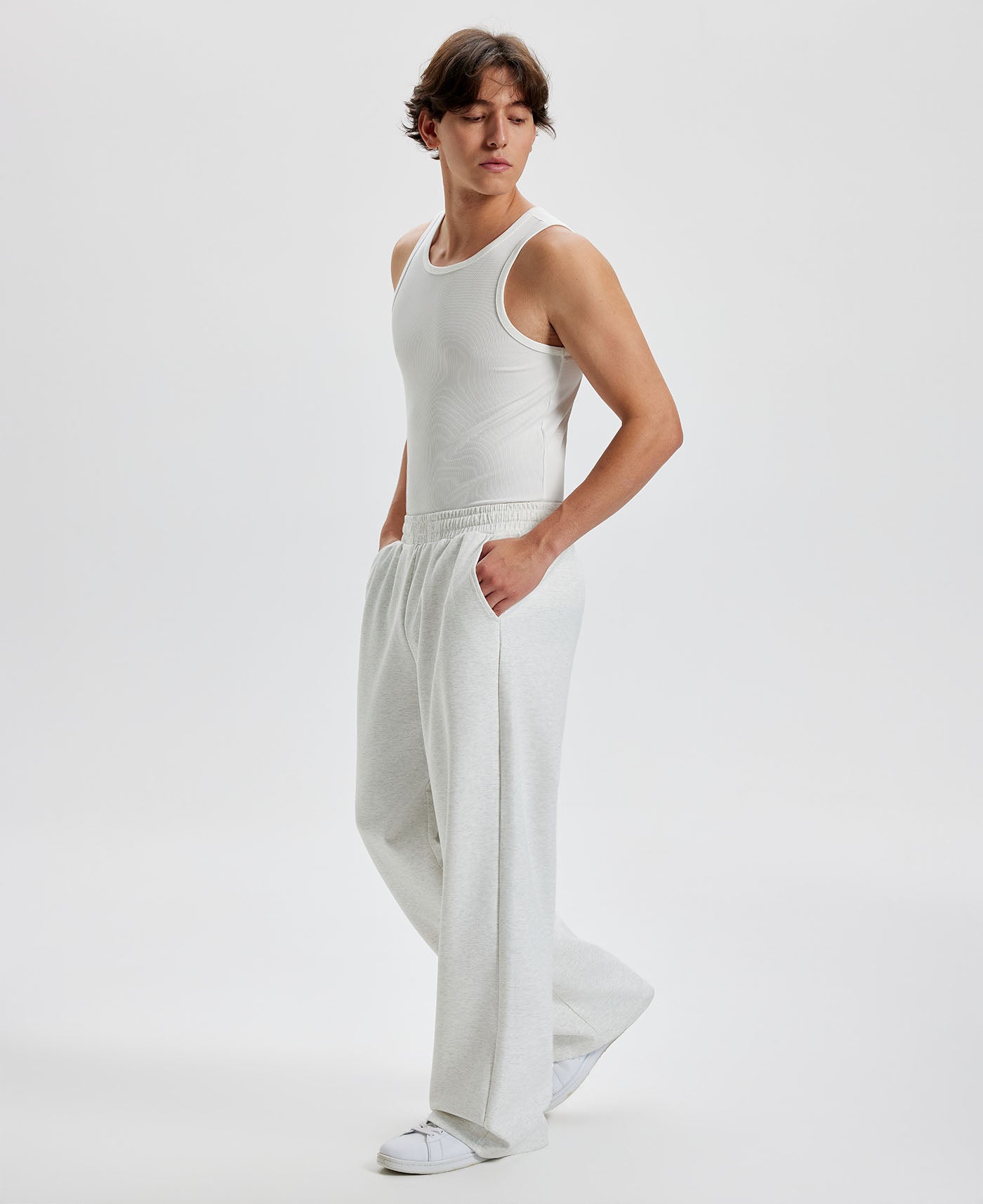 Men's white grey wide leg sweatpants, side view. Baggy pants men with roomy fit.