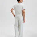 Cotton white grey sweatpants for men, back view. Elastic waistband and back pocket.
