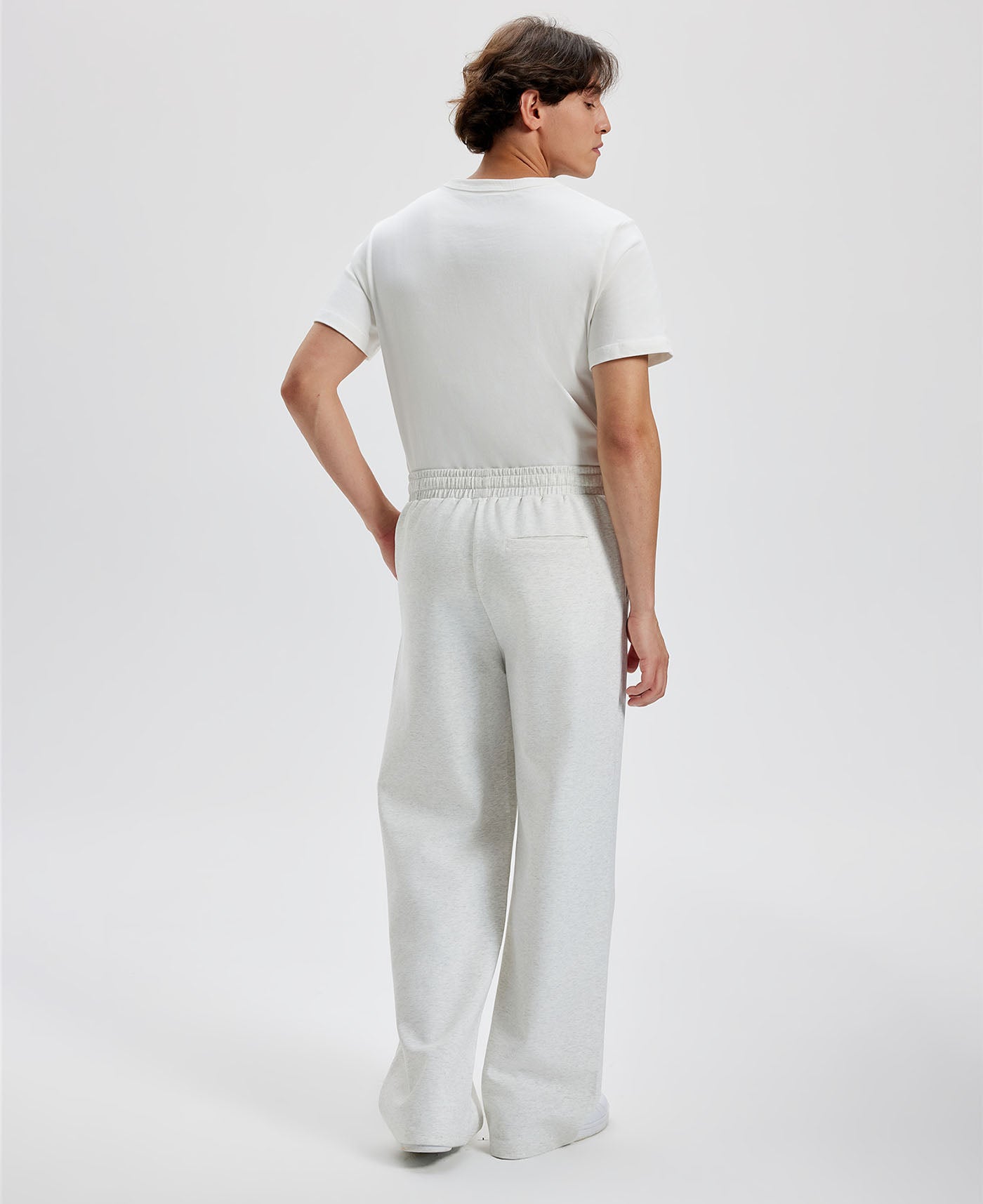 Cotton white grey sweatpants for men, back view. Elastic waistband and back pocket.
