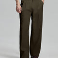 Man in white knit, coffee wide-leg dress pants and brown shoes¡ªhand in pocket showing pleated front and fluid drape.