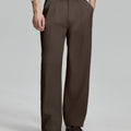 Man in white sweater, coffee pleated pants & brown shoes, showcasing the wide-leg cut and drape of Baggy Pleated Dress Pants for Men.
