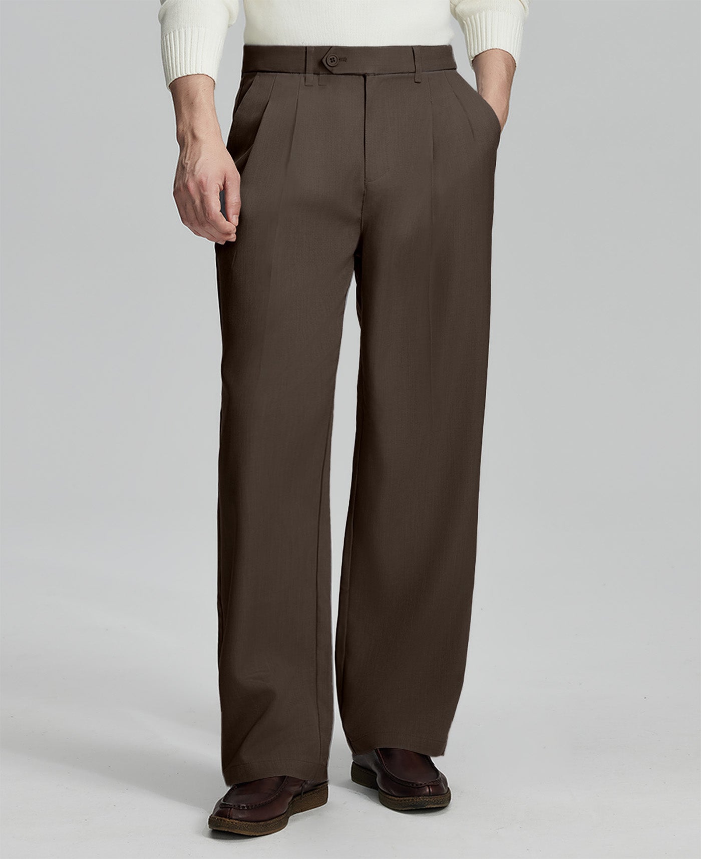 Man in white sweater, coffee pleated pants & brown shoes, showcasing the wide-leg cut and drape of Baggy Pleated Dress Pants for Men.