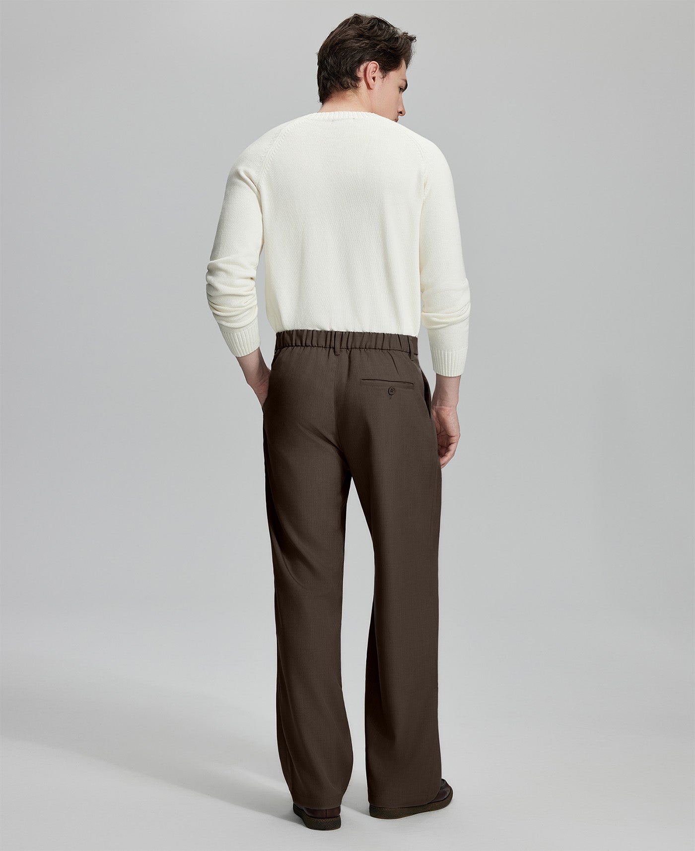 Back view of men's coffee dress pants showing elastic waistband and back pockets, emphasizing the silhouette of Extended Tab & Inner Drawstring design.