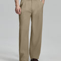 Man in white sweater, khaki pleated pants & brown shoes, showcasing the wide-leg cut and drape of Baggy Pleated Dress Pants for Men.
