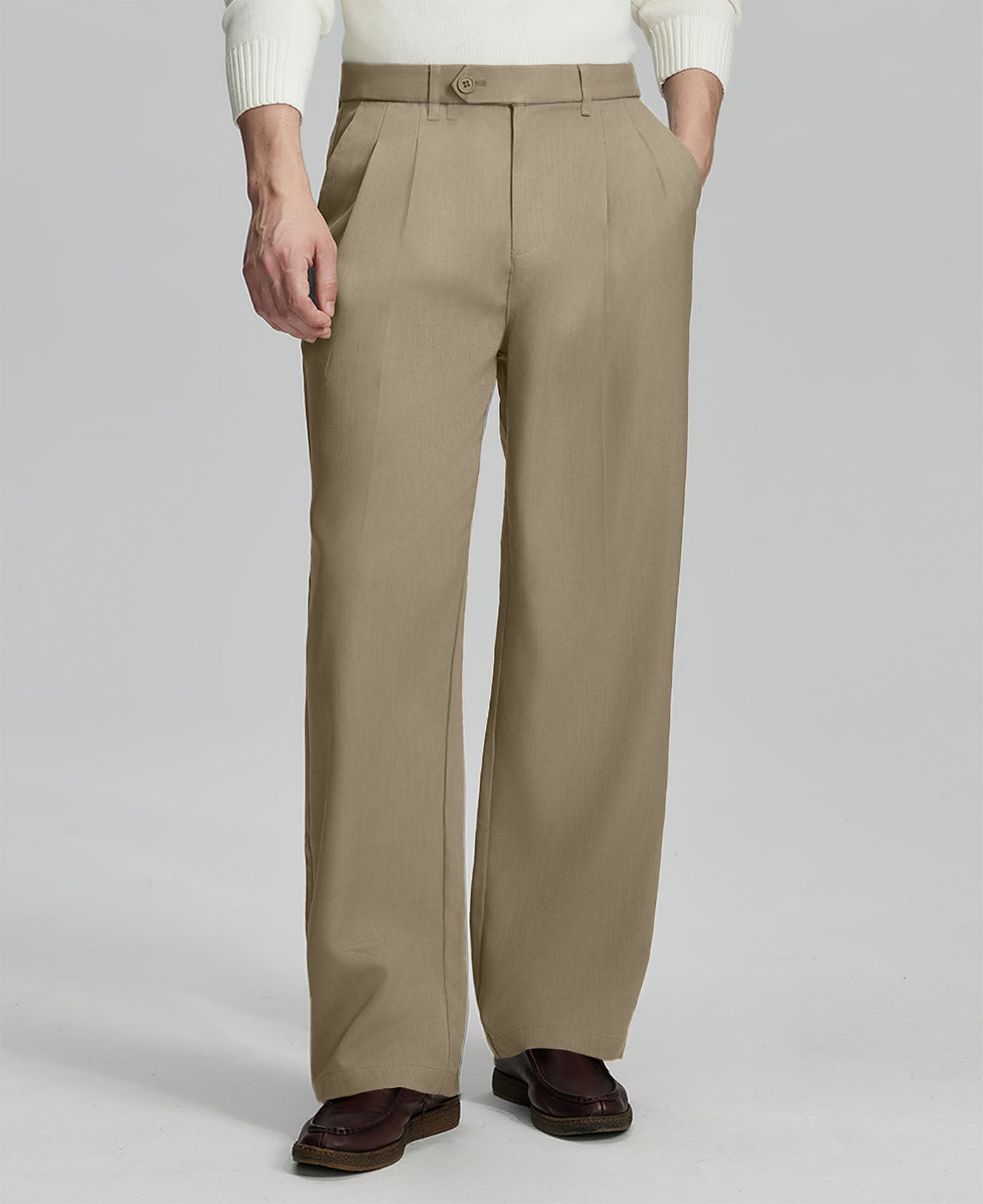 Man in white sweater, khaki pleated pants & brown shoes, showcasing the wide-leg cut and drape of Baggy Pleated Dress Pants for Men.