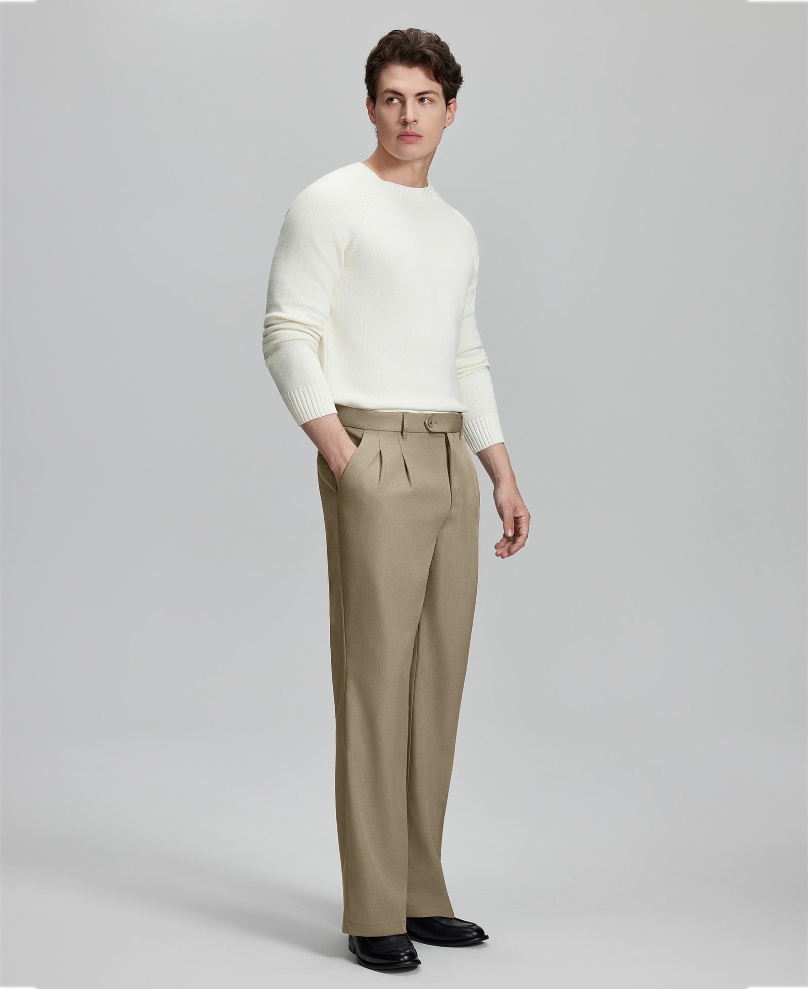 Side view of model with hand in pocket, highlighting the pleats and line of the Khaki Baggy Pleated Dress Pants for Men.