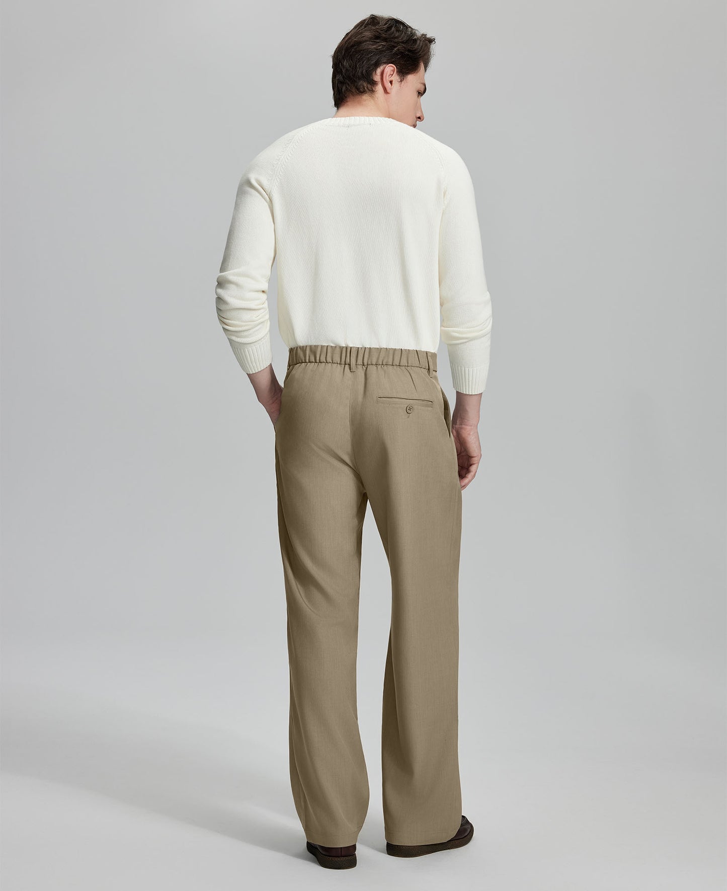 Back view of men's khaki dress pants showing elastic waistband and back pockets, emphasizing the silhouette of Extended Tab & Inner Drawstring design.