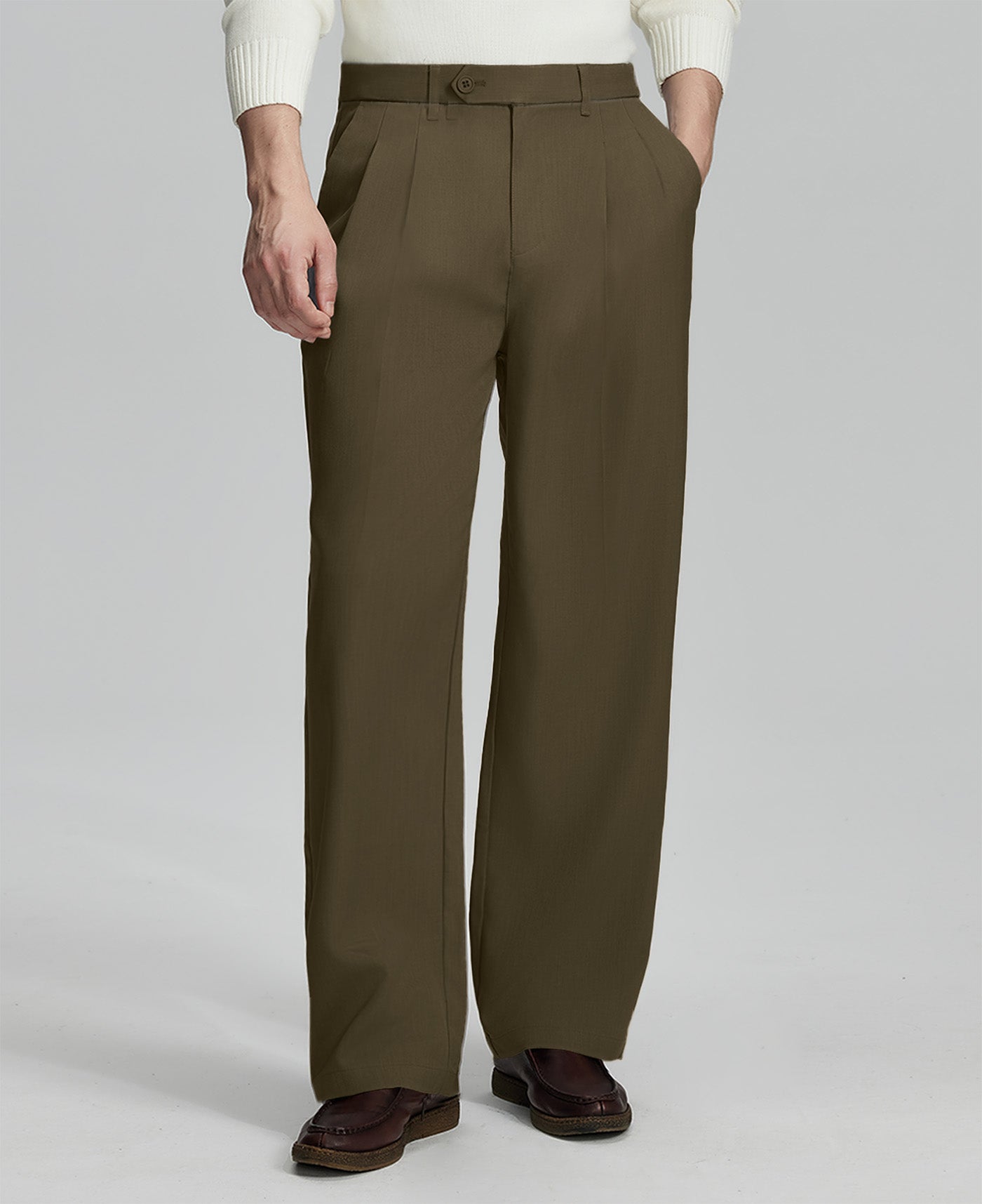 Man in white sweater, light brown pleated pants & brown shoes, showcasing the wide-leg cut and drape of Baggy Pleated Dress Pants for Men.