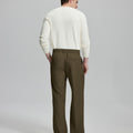 Side view of model with hand in pocket, highlighting the pleats and line of the Light Brown Baggy Pleated Dress Pants for Men.