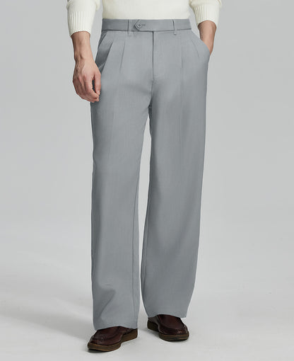 Man in white sweater, light grey pleated pants & brown shoes, showcasing the wide-leg cut and drape of Baggy Pleated Dress Pants for Men.