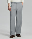 Man in white sweater, light grey pleated pants & brown shoes, showcasing the wide-leg cut and drape of Baggy Pleated Dress Pants for Men.