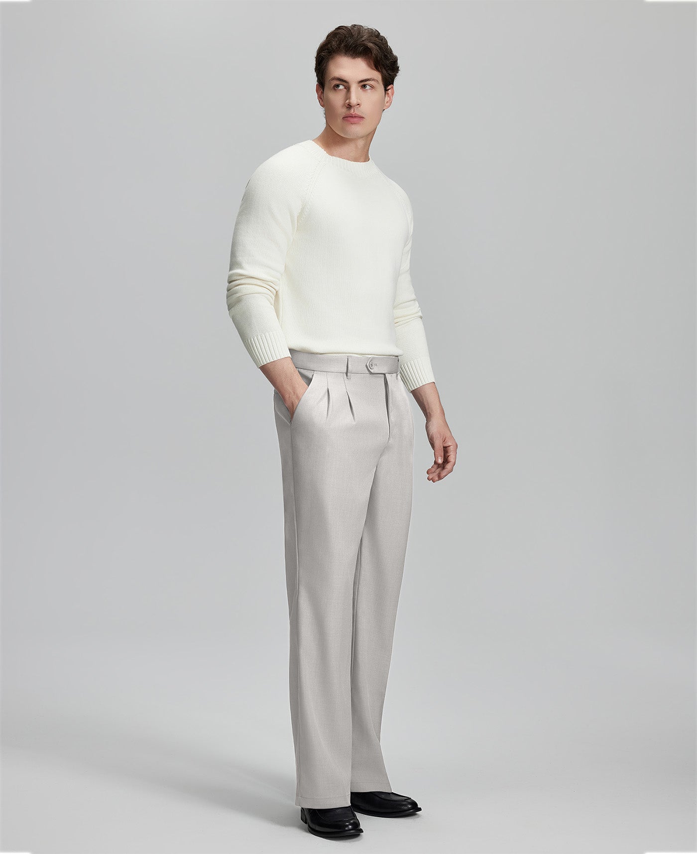 Side view of model with hand in pocket, highlighting the pleats and line of the Baggy Pleated Dress Pants for Men.