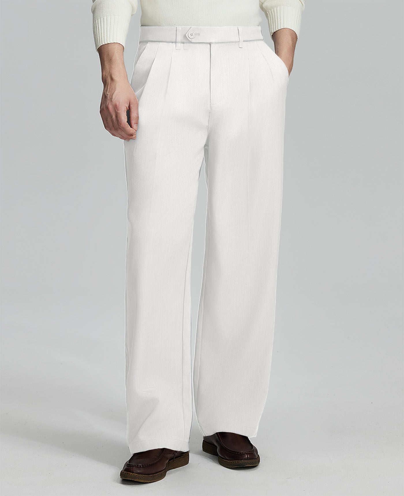 Man in white sweater, white pleated pants & brown shoes, showcasing the wide-leg cut and drape of Baggy Pleated Dress Pants for Men.