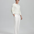 Side view of model with hand in pocket, highlighting the pleats and line of the White Baggy Pleated Dress Pants for Men.