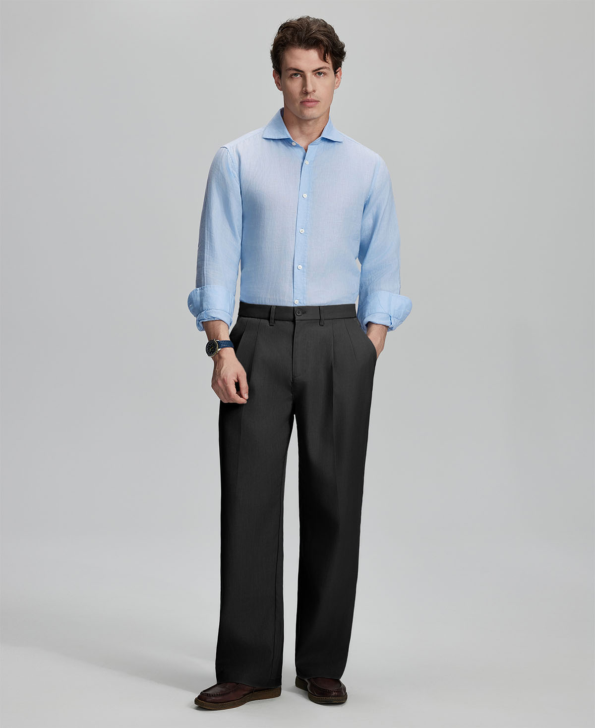 Model in light blue shirt and black trousers, presenting a complete outfit for a professional look.