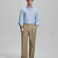 Model in light blue shirt and khaki trousers, presenting a complete outfit for a professional look.