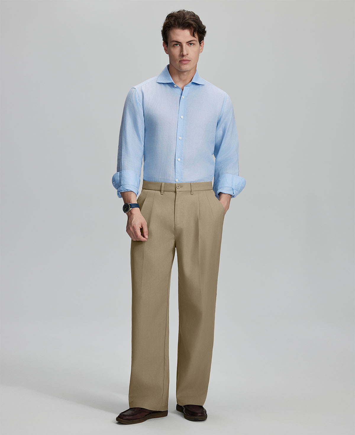 Model in light blue shirt and khaki trousers, presenting a complete outfit for a professional look.