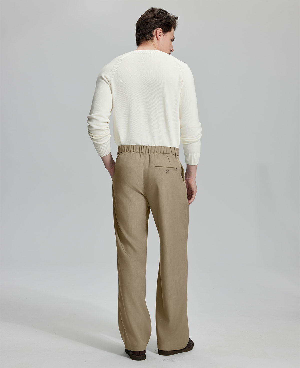Back view showing elastic waistband and rear pockets on men's vintage-style khaki dress pants for enhanced comfort.