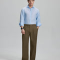 Model in light blue shirt and light brown trousers, presenting a complete outfit for a professional look.