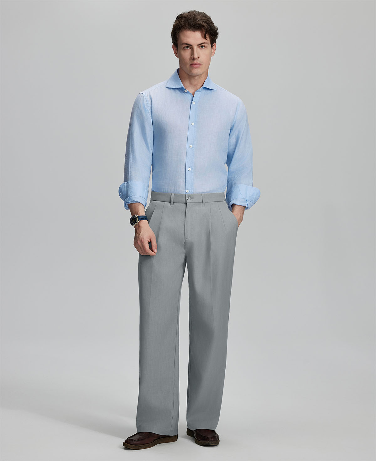 Model in light blue shirt and light grey trousers, presenting a complete outfit for a professional look.