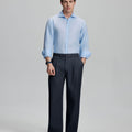 Model in light blue shirt and navy trousers, presenting a complete outfit for a professional look.