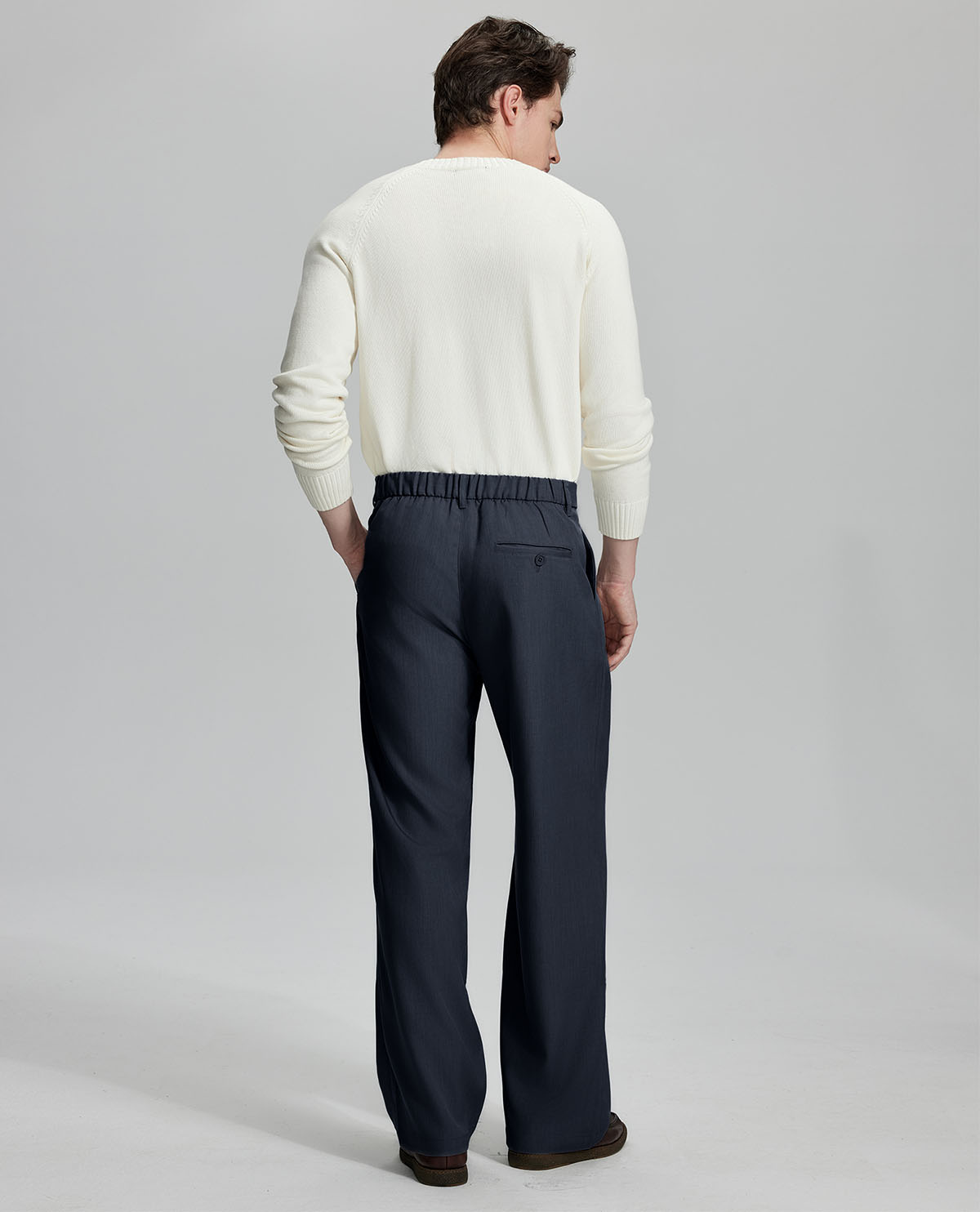 Back view showing elastic waistband and rear pockets on men's vintage-style navy dress pants for enhanced comfort.
