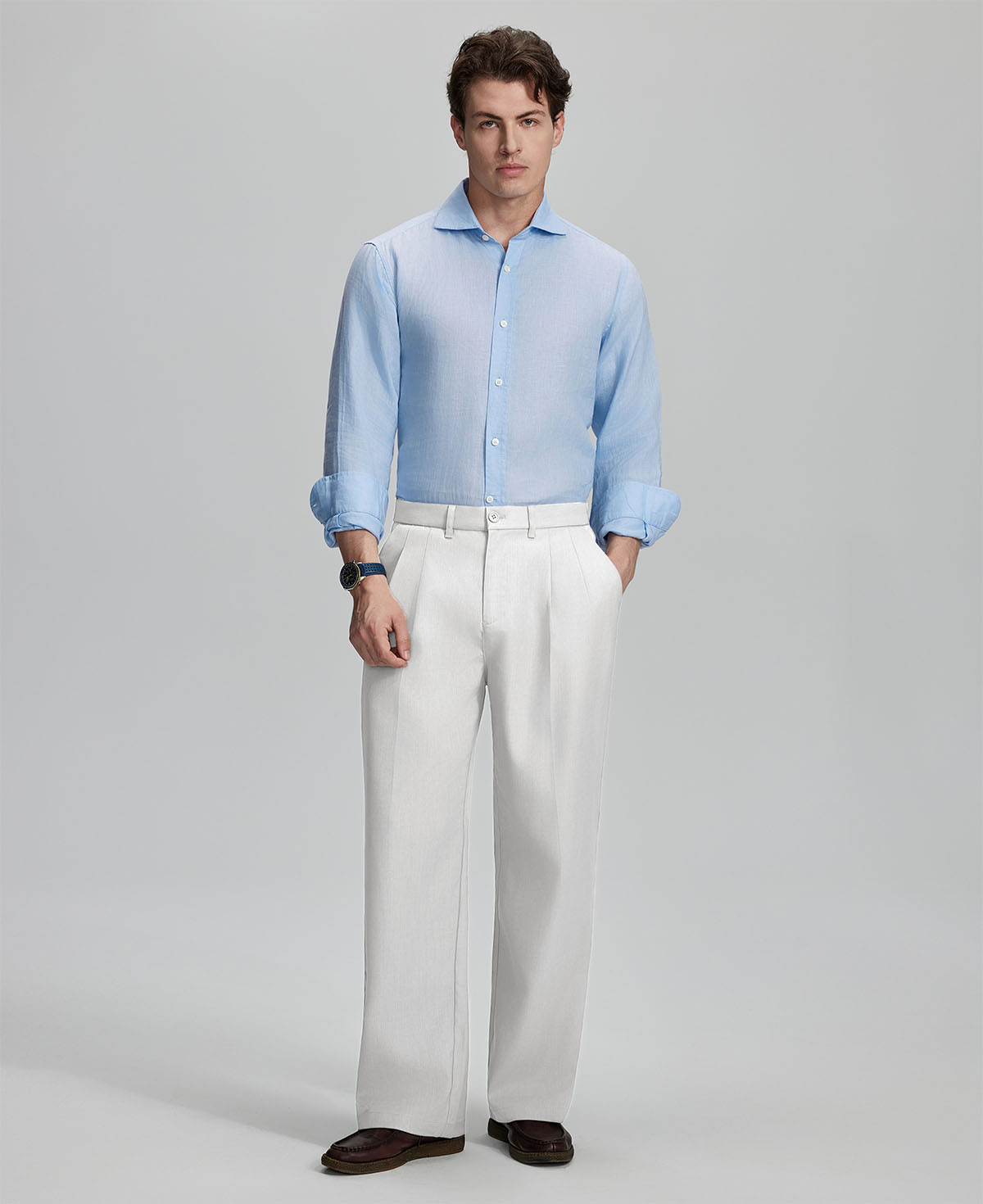 Model in light blue shirt and white trousers, presenting a complete outfit for a professional look.