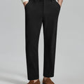 Man in white sweater, black Men's Corduroy Dress Pants, and brown loafers showing fabric texture and drape.