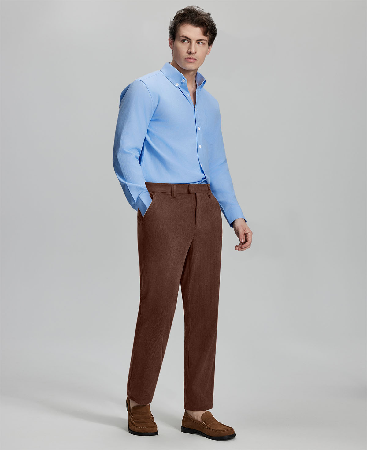 Model in light blue shirt and coffee Men's Corduroy Dress Pants, showcasing smart business casual style.