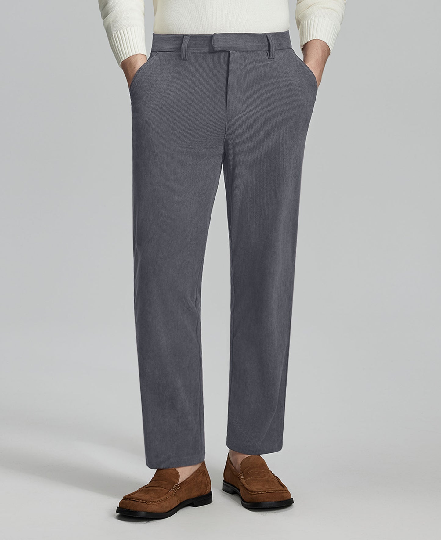 Man in white sweater, grey Men's Corduroy Dress Pants, and brown loafers showing fabric texture and drape.