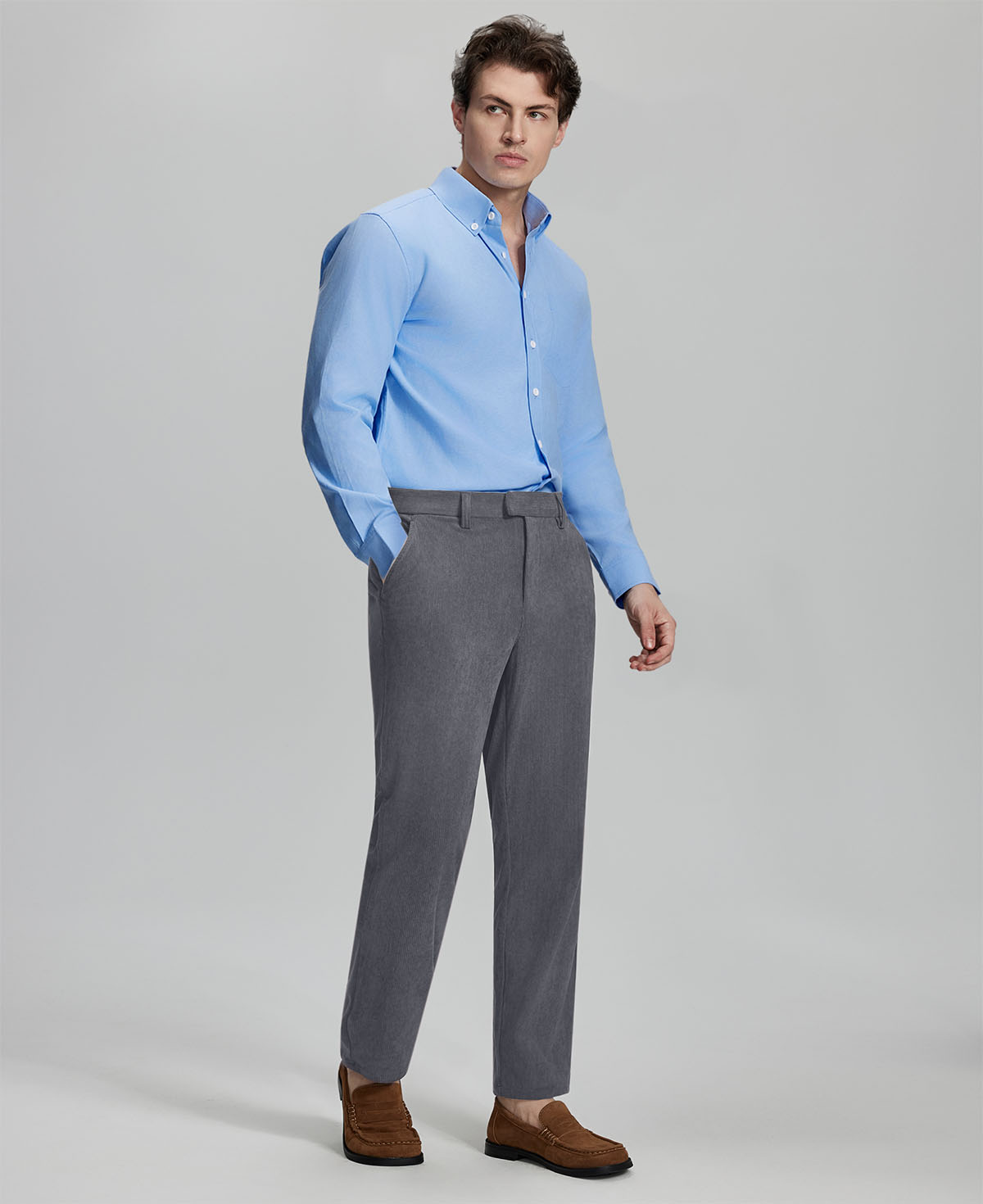Model in light blue shirt and grey Men's Corduroy Dress Pants, showcasing smart business casual style.