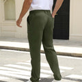 Back view of pants showing rear pocket design and overall silhouette, man with hand in back pocket for storage detail.
