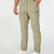 Man in khaki multipants with drawstring waist and multiple pockets, white sneakers, hand in pocket showing side logo.