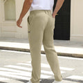 Back view of pants showing rear pocket design and overall silhouette, man with hand in back pocket for storage detail.