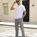 Man adjusting sunglasses, revealing side pocket details of light grey multipants, highlighting fit and pocket layout.