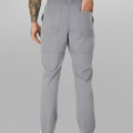 Close-up of back pocket and elastic waistband, emphasizing storage functionality and comfort in multipants.